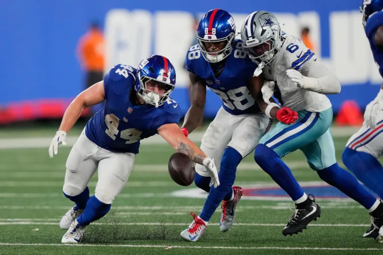 Giants' offense rolls over the Cowboys to give coach John Harbaugh a win in his debut